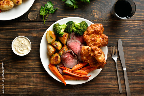 Sunday Roast with roasted beef, carrots, crispy potato, broccoli and yorkshire pudding