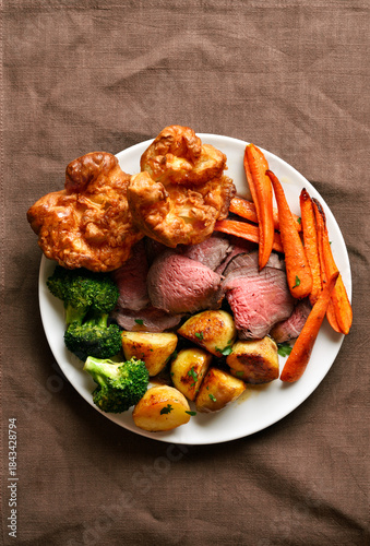 Sunday Roast with roasted beef, carrots, crispy potato, broccoli and yorkshire pudding