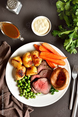 Sunday Roast with roasted beef, carrots, crispy potato, green pea and yorkshire pudding