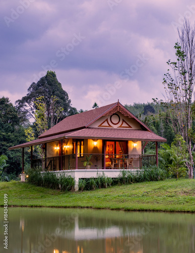 фотографія A beautiful lakeside bungalow in Khao Sok, Thailand, surrounded by lush greenery and mountains
