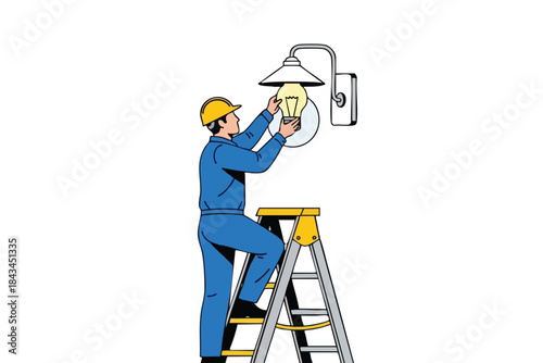 An electrician in blue overalls is changing a lightbulb on a ladder, side view
