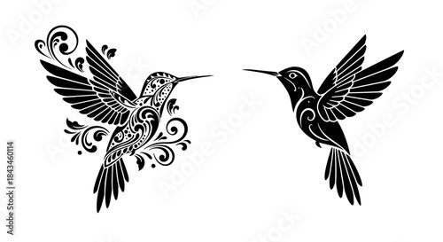 Two elegant black hummingbird silhouettes, one with intricate floral patterns and the other a simpler design, flying with outstretched wings.