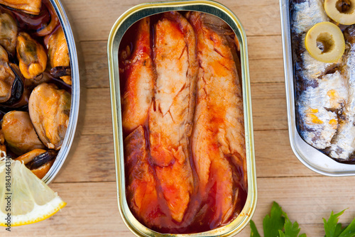 Three different opened cans of preserved