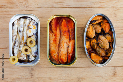 Three different opened cans of preserved