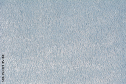 A soft light blue fleece fabric texture is shown in a close up view