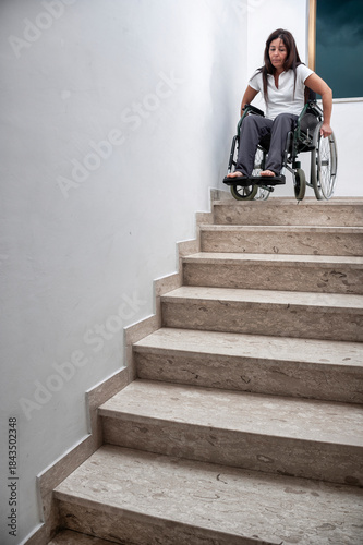 Woman in Wheelchair Facing Architectural Barrier on Staircase