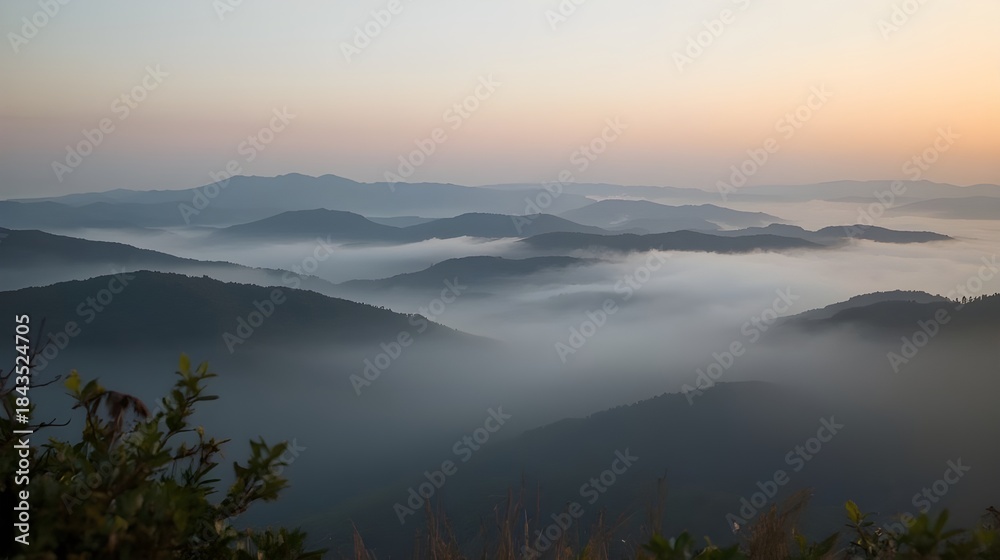 Fototapeta premium Misty mountain landscape with layered hills