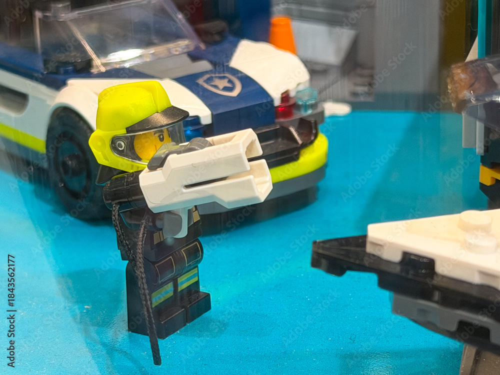 Naklejka premium Lego police figure with weapon and car