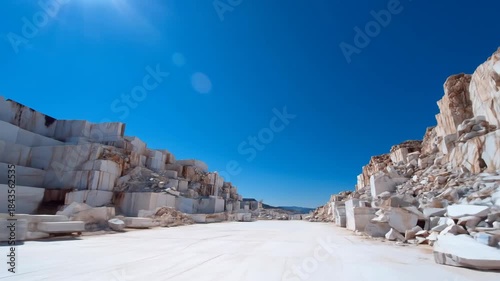 Massive marble quarry landscape white stone walls blue sky industrial site