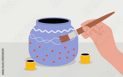 An artistic image of a hand painting a decorative jar, displaying creativity with colorful patterns and paint, showcasing the joy of crafting and self-expression.