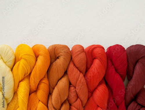 Colorful hand-dyed yarn skeins stacked horizontally