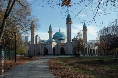 The mosque in herbert von king park stands majestically amidst a tranquil autumn landscape, showcasing its beautiful islamic architecture