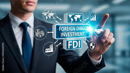 A person pointing on FOREIGN DIRECT INVESTMENT for the concept of global finance and investment.
