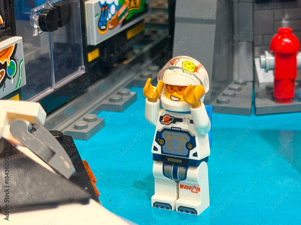 Fototapeta premium Cheerful lego astronaut in colorful playset