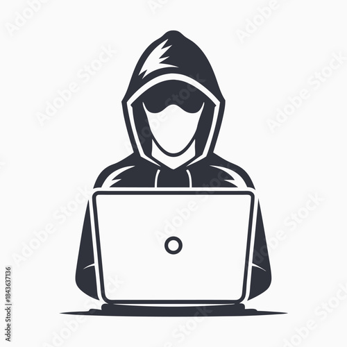 Silhouette hacker wearing a hoodie works on a laptop while concealing identity with dark glasses