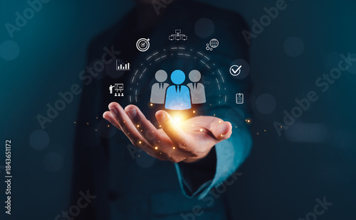Customer Relationship Management concept showing a businessperson using digital technology to manage and analyze customer data for marketing and sales strategy in modern business.