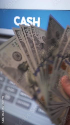 A man withdraws cash from an ATM. Banking services, cash withdrawals