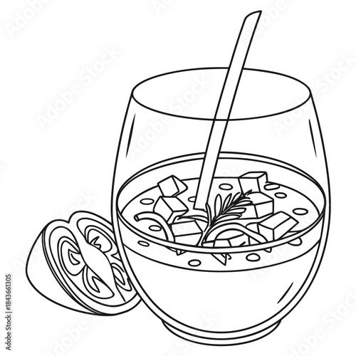 A refreshing chilled soup or gazpacho in a clear glass with a spoon and a slice of tomato and herbs for garnish