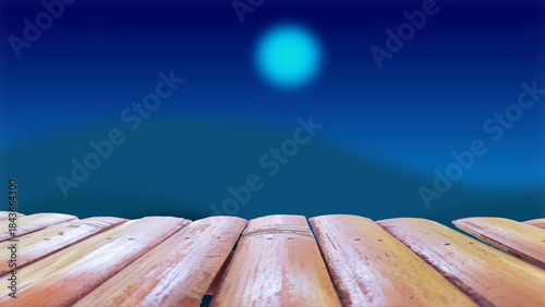 A wooden table with a blurred background of the sky and moon at night.