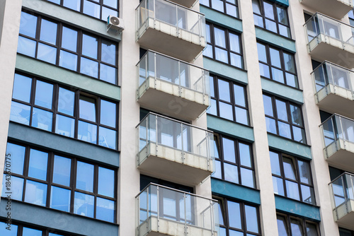 Contemporary city building, Modern residential tower featuring reflective windows and minimal design