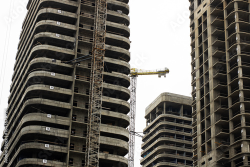 City scaffolding and structural details, Modern building with crane and exposed elements
