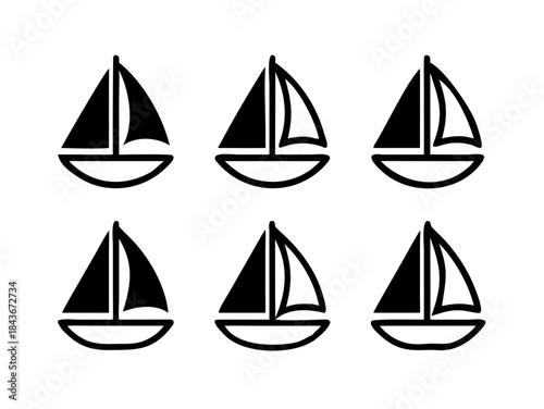 A black and white image of a cat sitting in a box