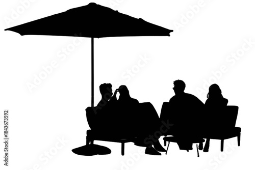 Four friends relaxing outdoors under a parasol on a sunny day.