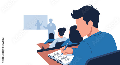 University student attentively taking notes in a notebook during a lecture in a classroom full of other young people.