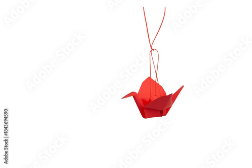 simple red paper origami crane suspended and gently hanging from a thin dark string, no background svg