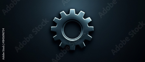 Brushed metallic gear icon with polished edges centered on a dark background featuring subtle diagonal lines, evoking mechanics and settings