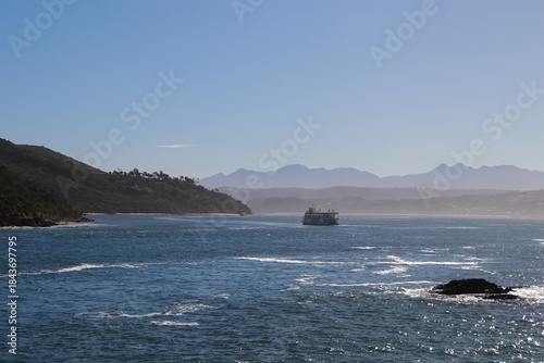 Knysna River Ferry Boat With Nature Covered Riverbank And Distant Mountain Horizon, South Africa