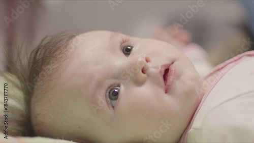 Adorable newborn baby girl lying in a crib