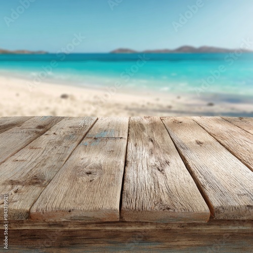 A weathered wooden surface overlooks a blurred idyllic beach with turquoise water