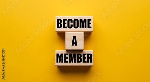 Wooden blocks spell become a member against a bright yellow background for signup