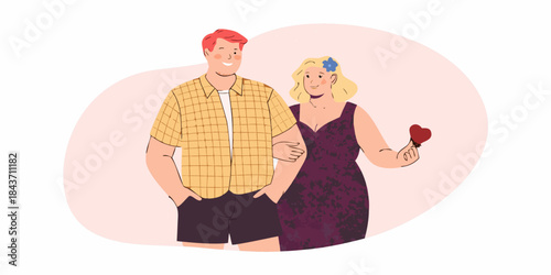 A couple stands closely together a woman holding a red heart shape