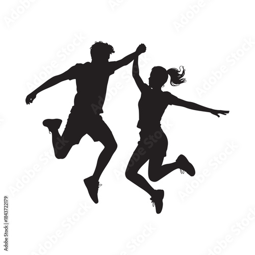 A joyful couple silhouetted in a dynamic moment of celebration and leaping