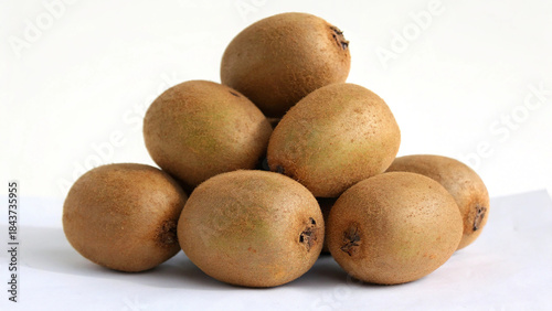 Heap of golden kiwifruit isolated on white background, showcasing their unique texture and vibrant color in a studio shot