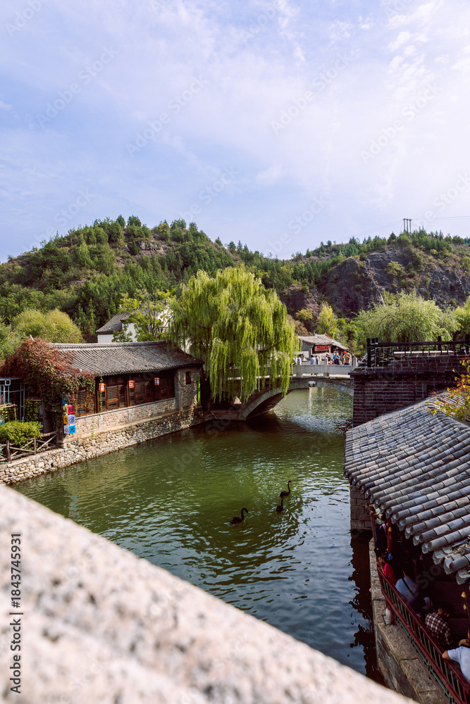 Fototapeta premium Traditional waterfront village and lake in Gubei Water Town China