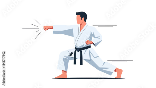 Young Male Martial Artist Performing a Karate Kick in a Studio