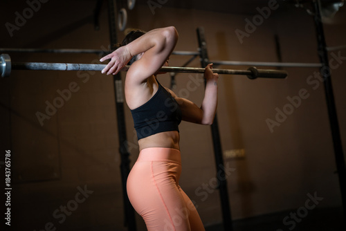 Woman With Barbell And Focused Posture, Fitness Enthusiast Eager For Exercise With Proper Form, Female Athlete Aligning Hips And Maintaining Breath During Weight Training Session, Athlete In Stance