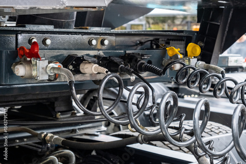 Pneumatic pumping hoses and connections of the body with the trailer to the truck. Closeup of pneumatic hoses for supplying compressed air to the truck. Semi-trailer, Truck MOT maintenance repair.
