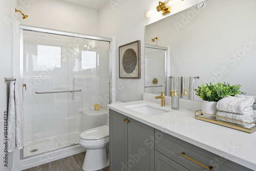 Bathroom with a white toilet and a shower stall