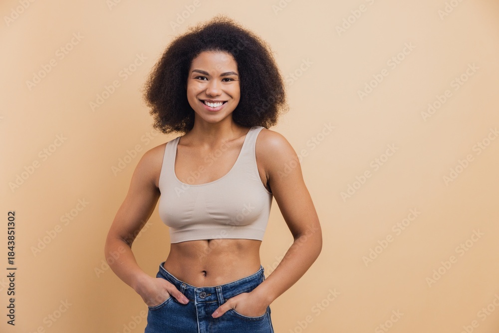 Fototapeta premium Young African American woman smiling looking at camera