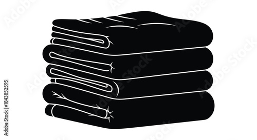 A neat stack of folded black towels presented in a stark dramatic silhouette