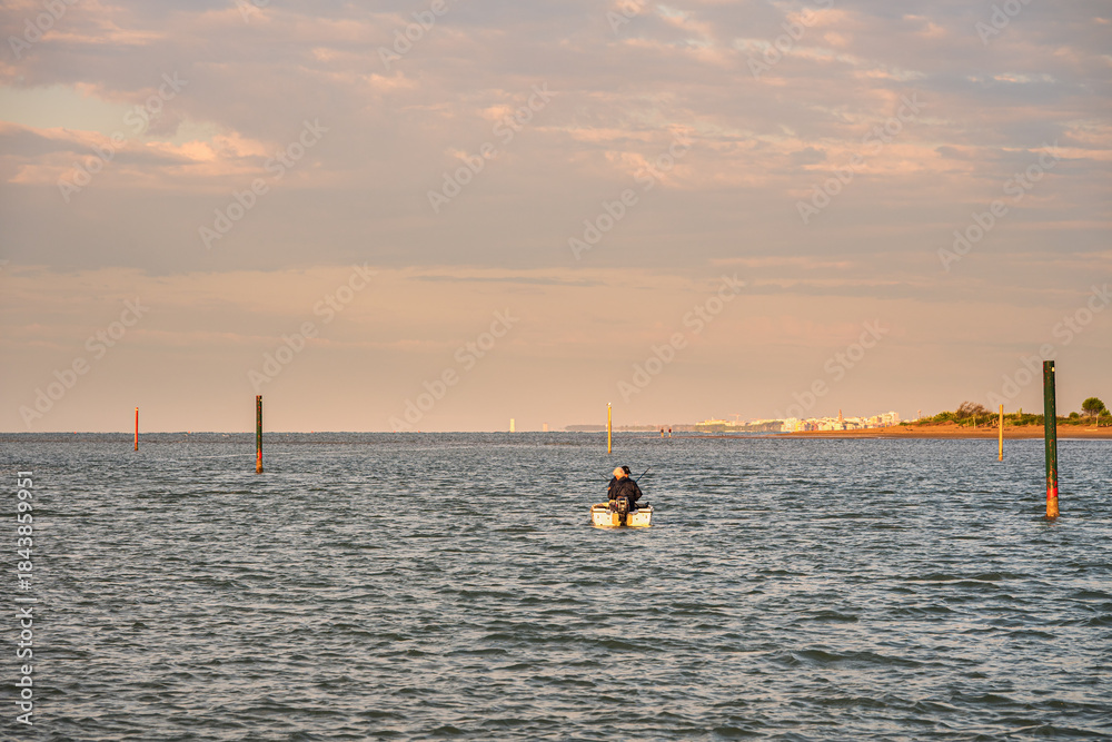 Fototapeta premium summer sunrise over the lagoon meets the sea, Bibione Pineda, Venice, Italy