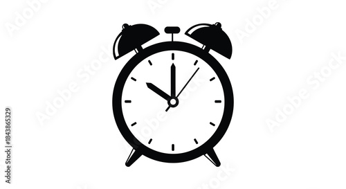 A classic black alarm clock displaying ten minutes past the hour a striking silhouette