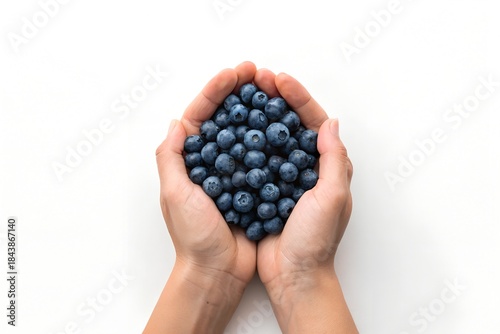 hand holding blueberries in palm on a white background 