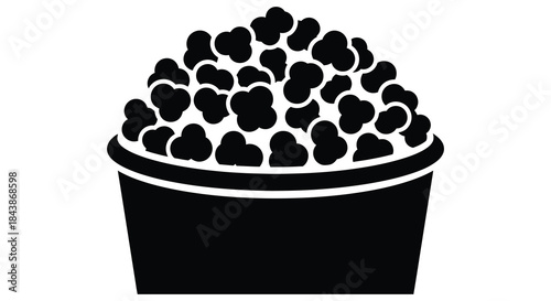 A black and white graphic depiction of a full popcorn bucket a delightful silhouette