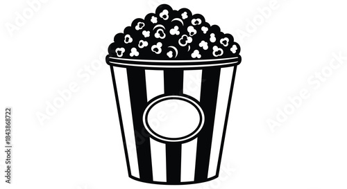 A classic black and white striped bucket overflowing with fluffy popcorn a delightful silhouette