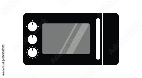 A simple black microwave oven with control knobs and a dark window silhouette